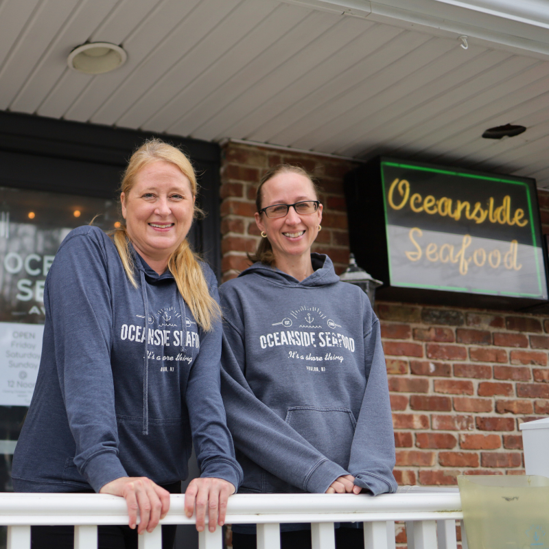 Michele and Jojo standing in front of Oceanside Seafood in Avalon, New Jersey.